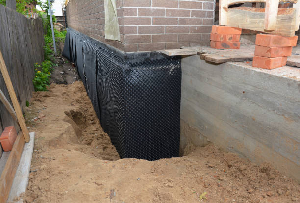 Happy homeowners after waterproofing job in Erie